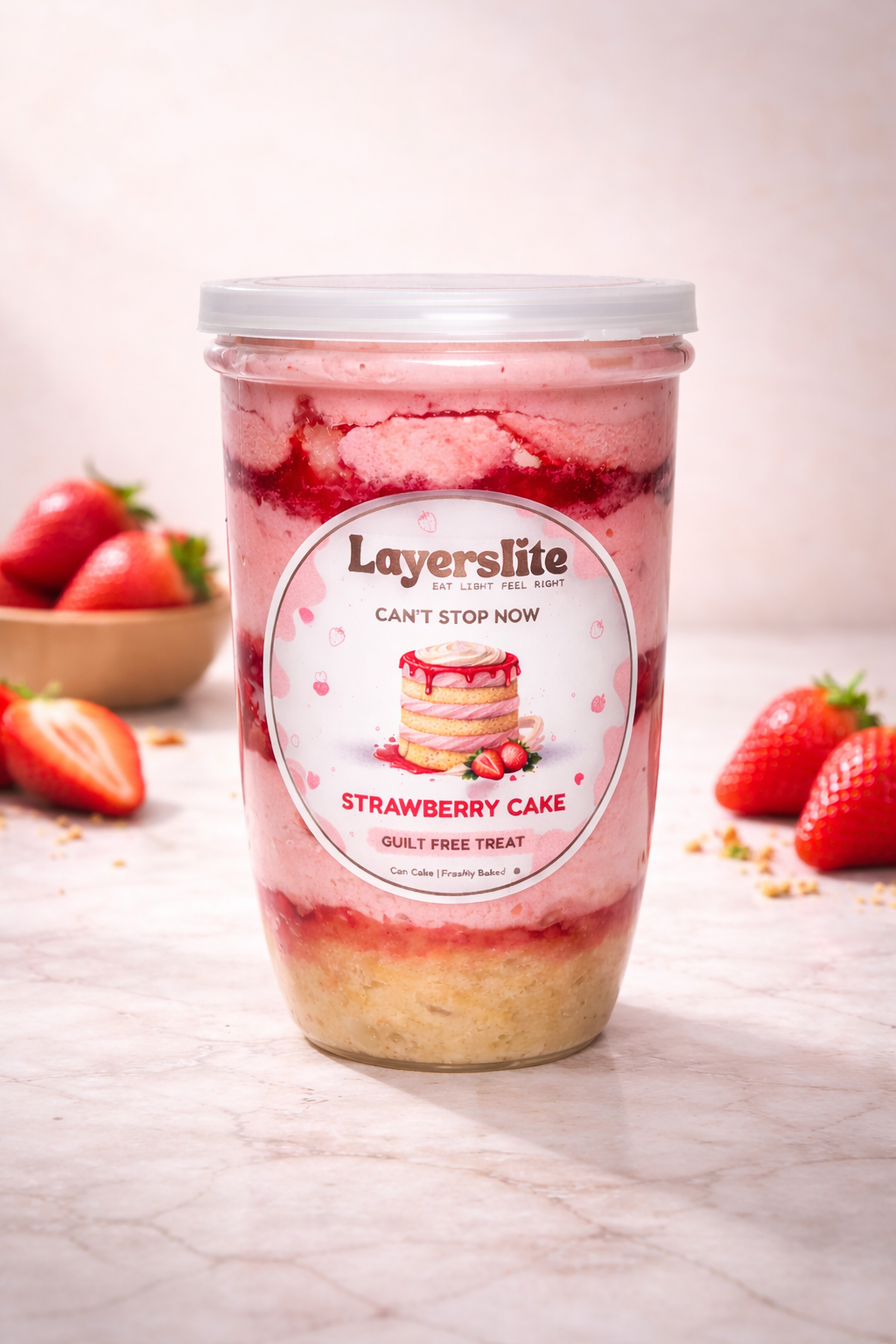 Strawberry cake layered dessert in a jar with 'Layerslite' branding on a light background.